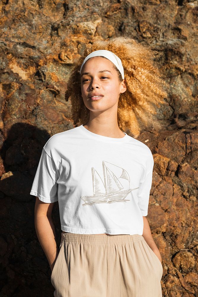 Aesthetic white crop top mockup psd with ship sketch women&rsquo;s apparel outdoor shoot