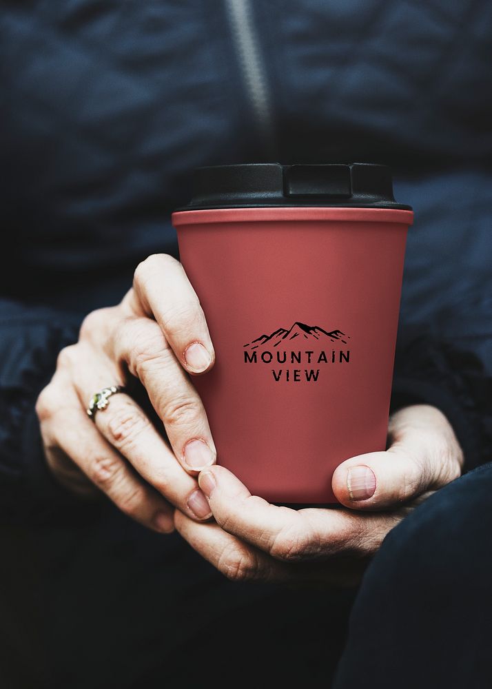 Senior woman holding reusable travel mug