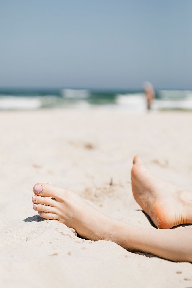 Woman relaxing in the sand at a beach
