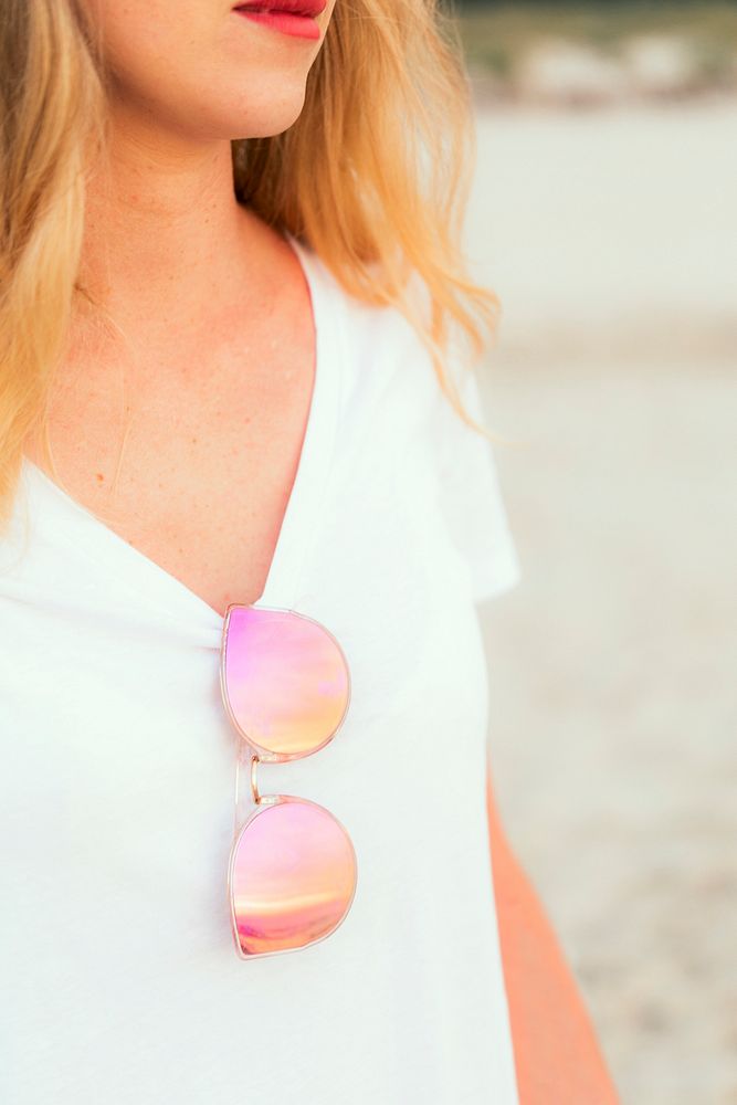 Woman with pink sunglasses at the beach