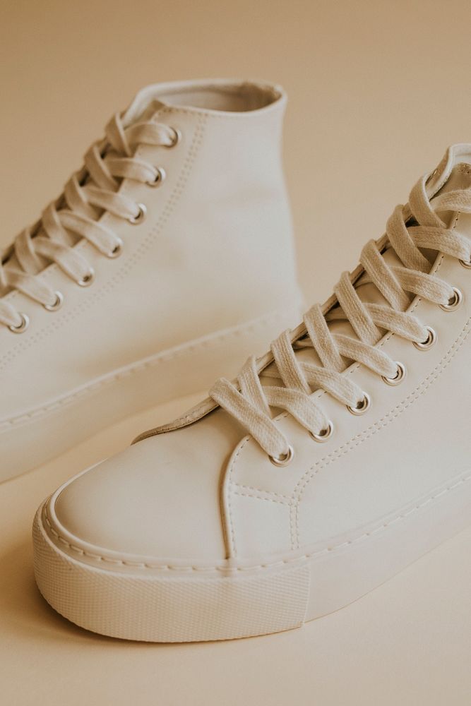 White high top sneakers on beige