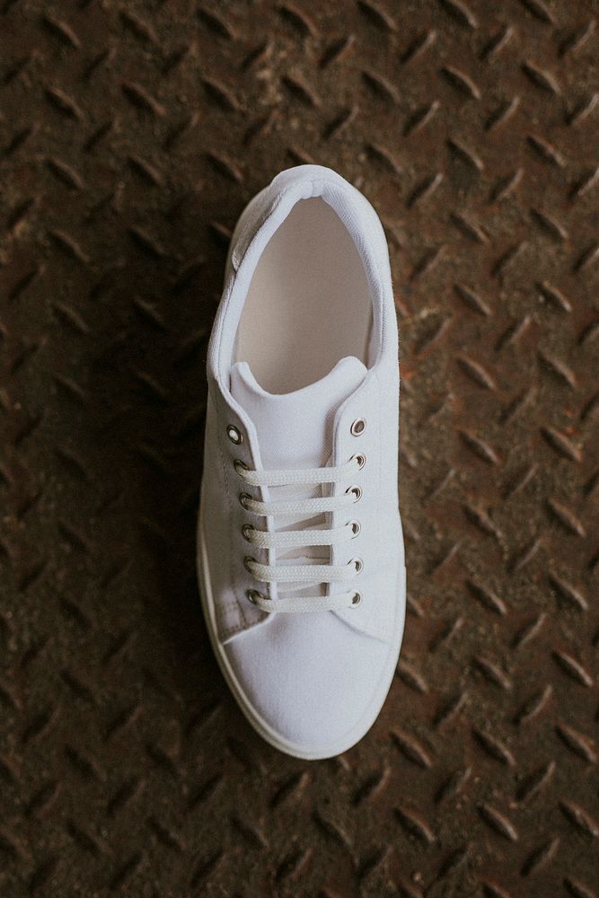 White canvas sneaker psd shoe on metal floor