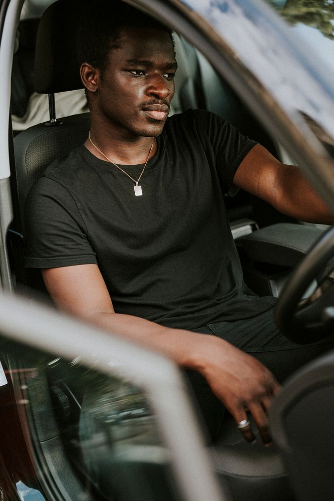 Handsome African American man driving a car