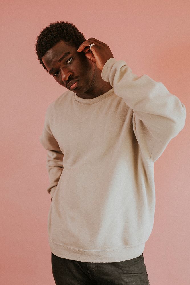 African American man wearing white sweater mockup on pink background