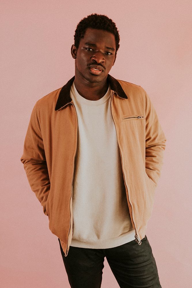 Black man in brown jacket mockup on pink background studio shot