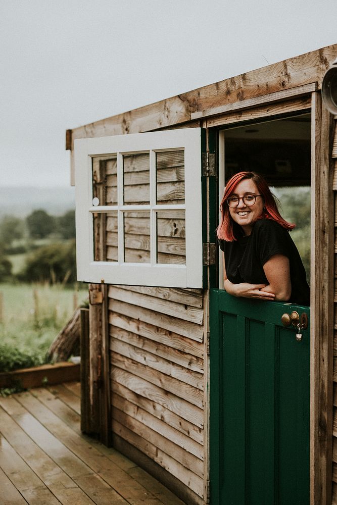 Cheerful woman in a wooden house
