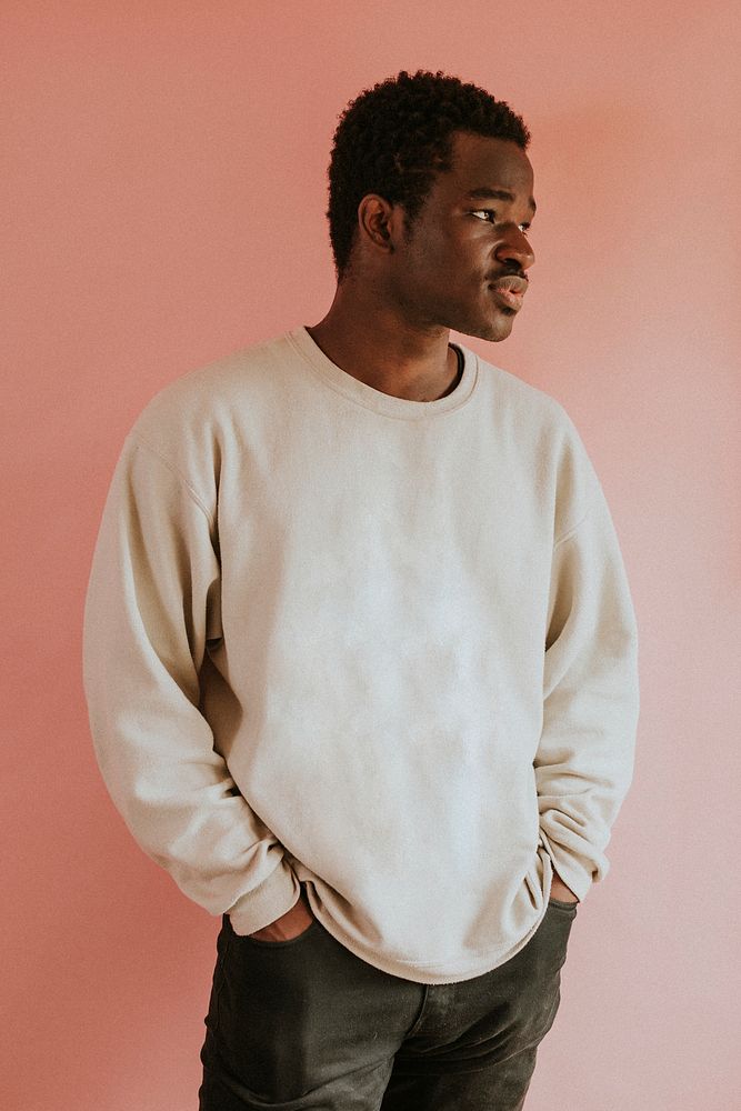 African American man wearing white sweater mockup on pink background