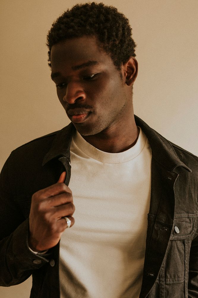 Men's black jeans jacket mockup on African American male model in studio shot