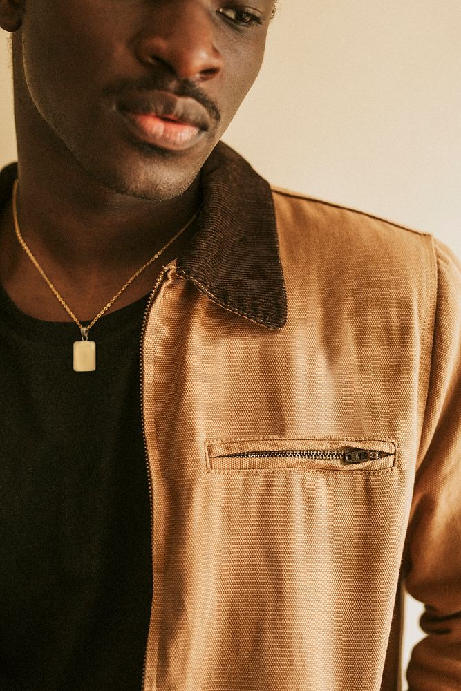Brown short jacket mockup on African Amercan male model in studio