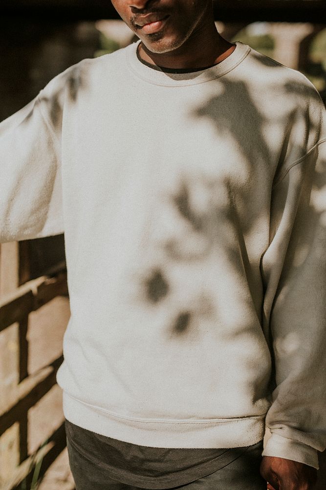 Men's white college sweater mockup outdoor shoot