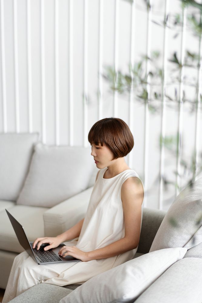 Woman working at home in a Scandinavian decor living room