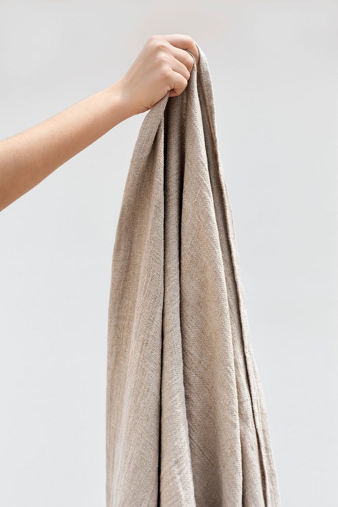 Woman holding a brown simple throw blanket