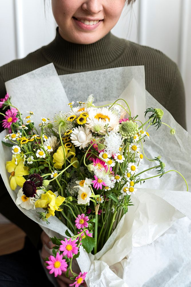 Woman carrying a bouquet of flowers