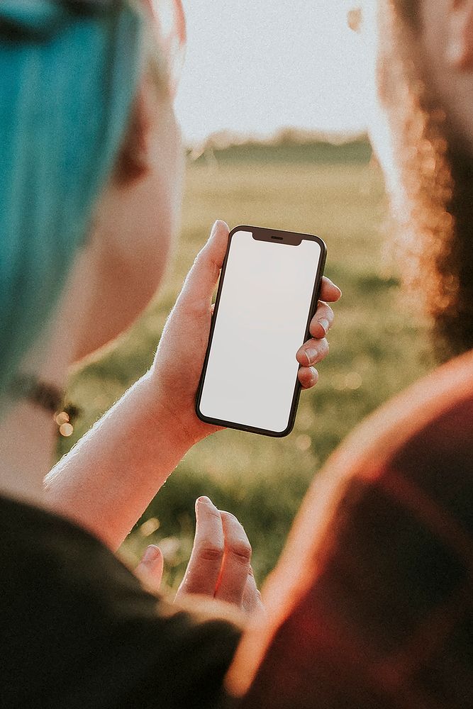 Couple looking at phone screen mockup psd