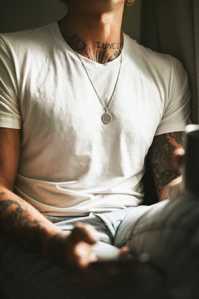 Urban tattooed man in white tee