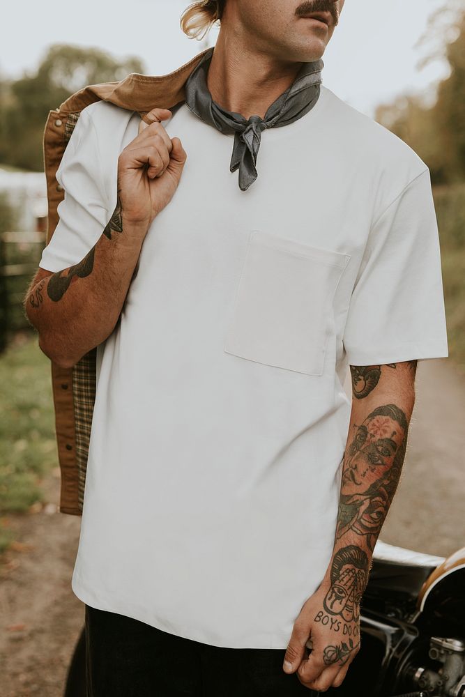 Man in white t-shirt with design space standing by the countryside