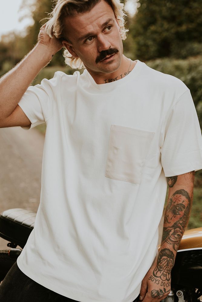 Man in white t-shirt with design space standing by the countryside