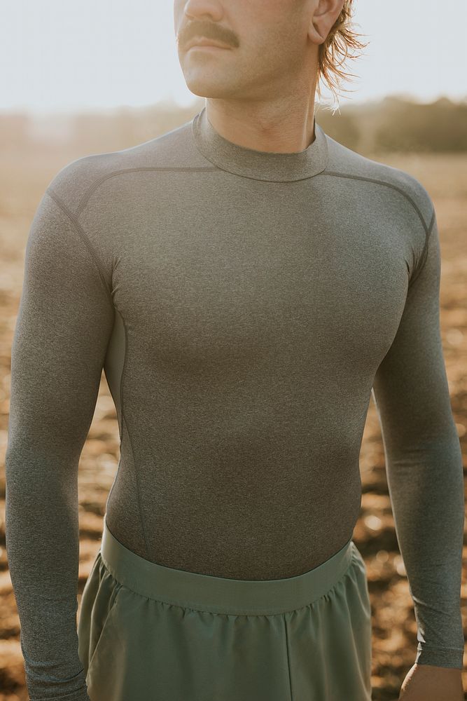 Mustache man in gray midweight stretch shirt standing in the countryside