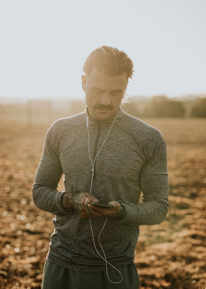 Cool urban man listening to music while working out