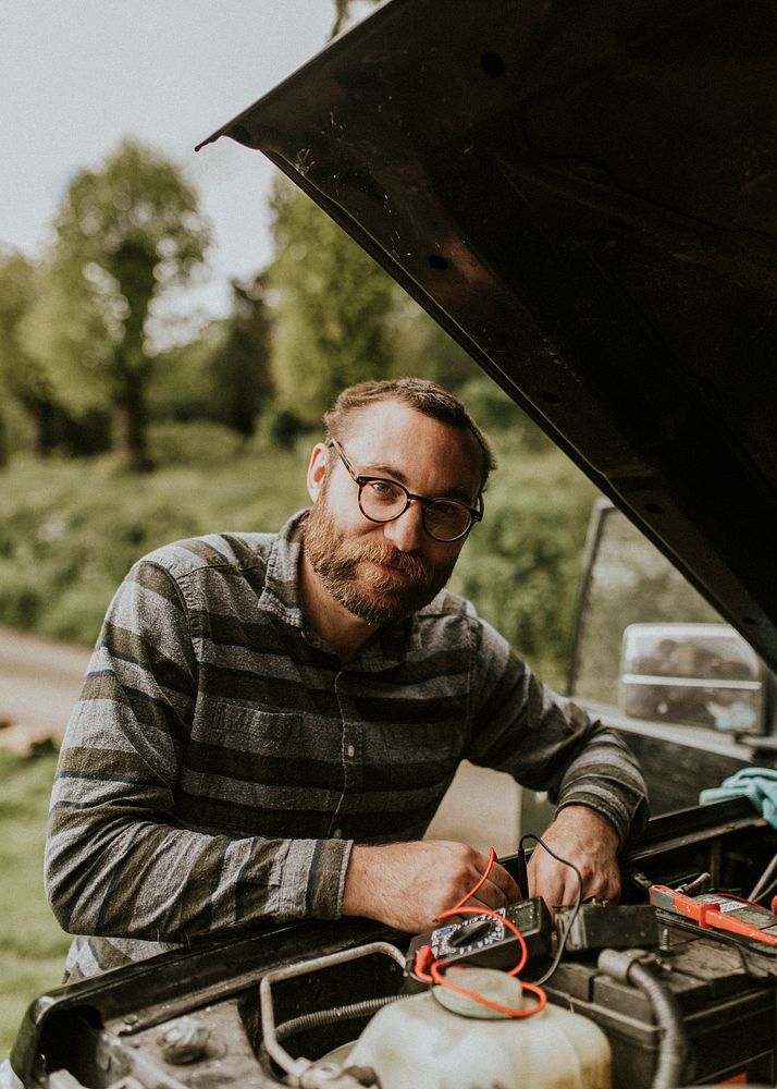 Man fixing a car outdoors auto repair service