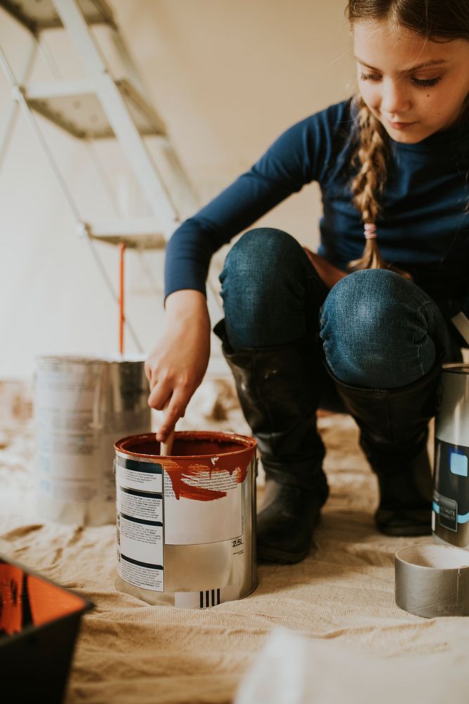 Child painting walls for home transformation