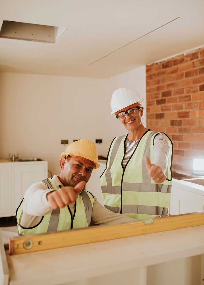 Contractor coworkers thumbs up at a construction site