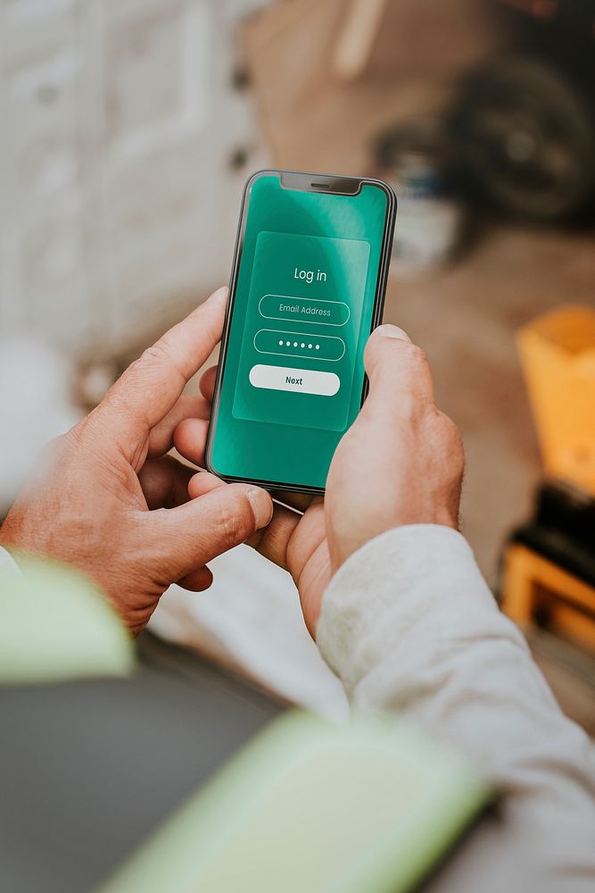 Smartphone screen mockup psd held by a middle aged man