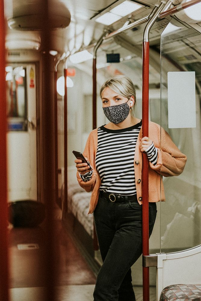 Woman using a phone on a train in the new normal