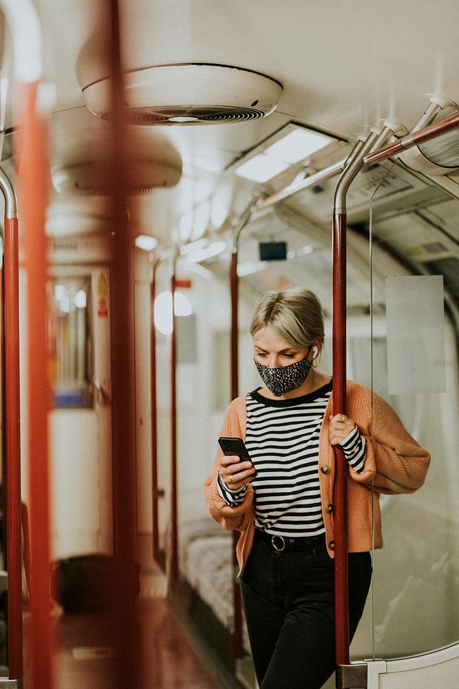 Woman using a phone on a train in the new normal