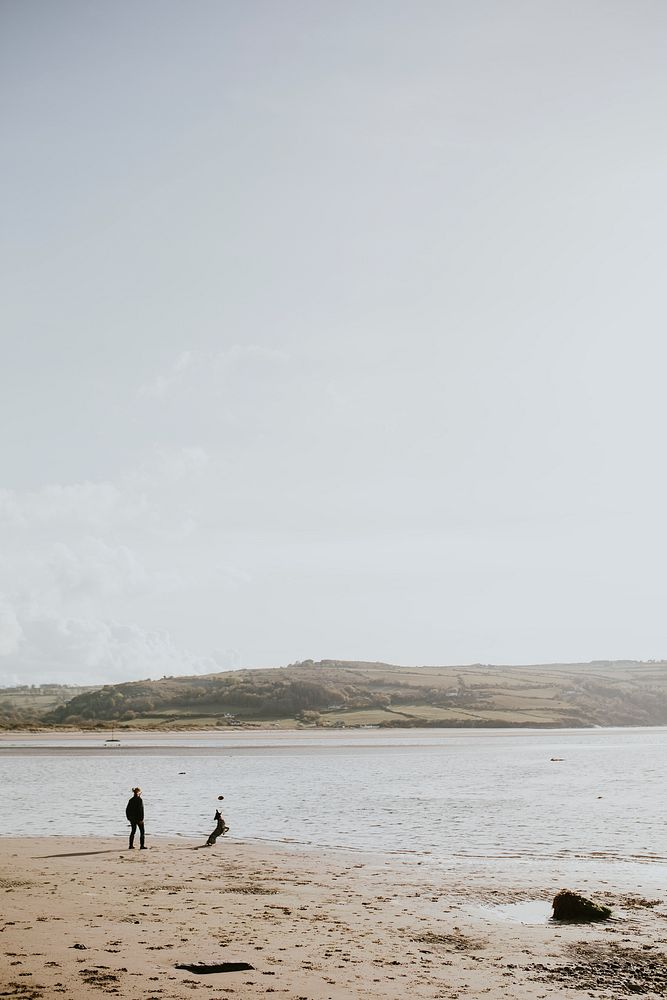 Senior man walking his dog on a coastal trail