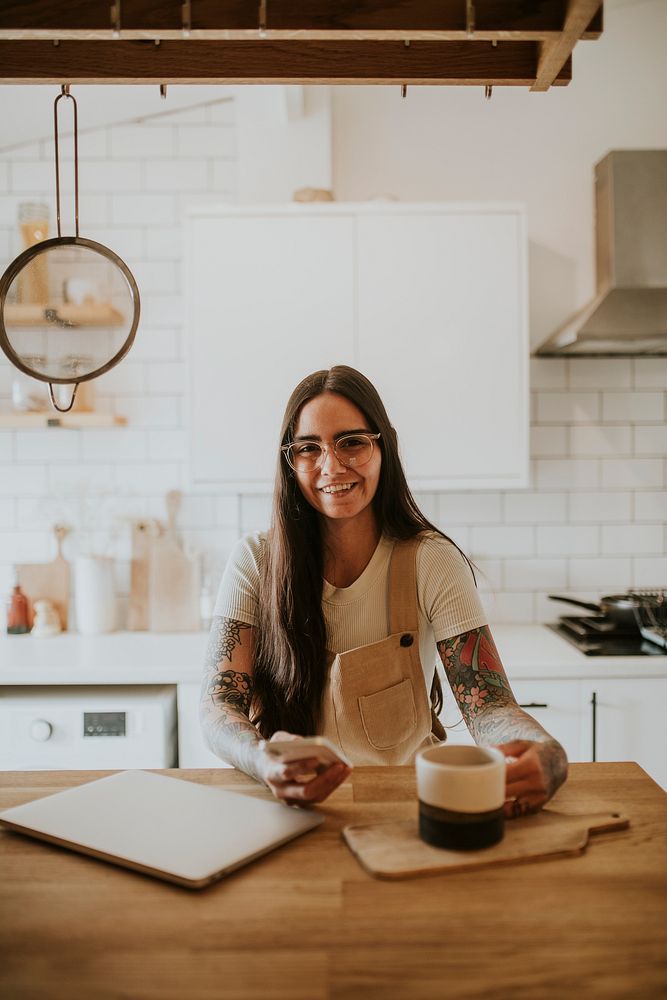 Woman in her 30s work from home on a dining table