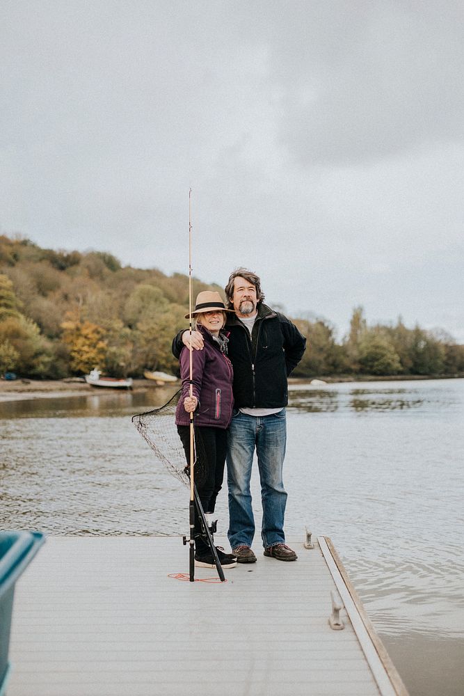 Senior couple posing while on a fishing trip