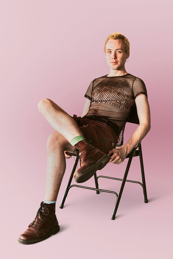 Non-binary person psd, sitting on a chair