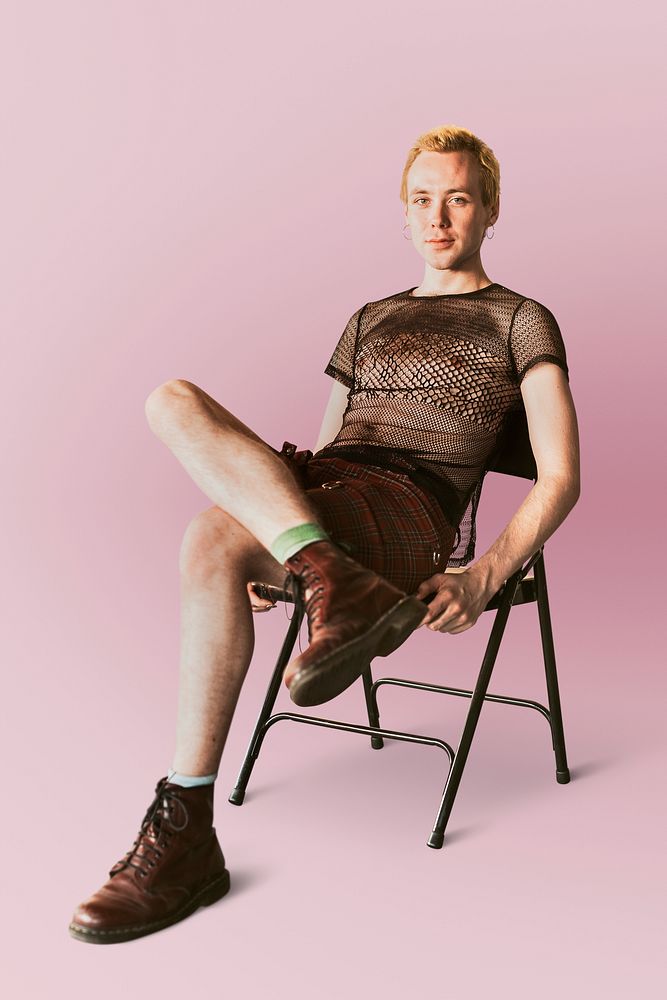 Non-binary person sitting on a chair