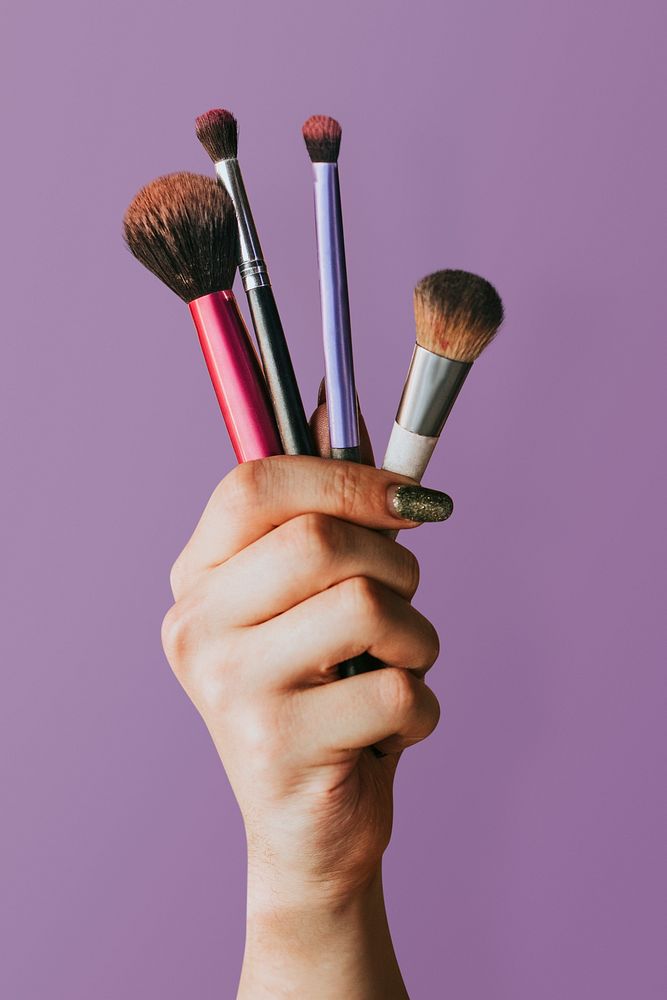 Beauty blogger holding makeup tools