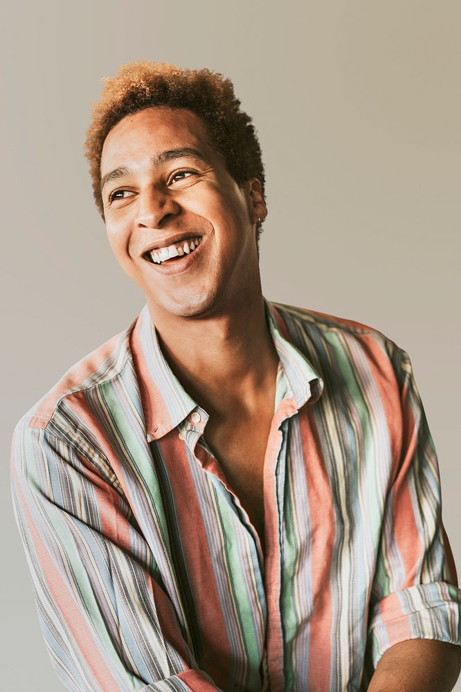 Happy non-binary person in a striped shirt