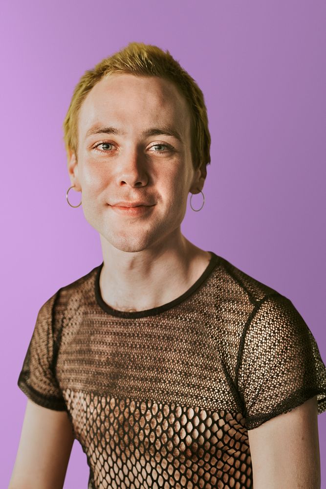 Happy non-binary person in a mesh top