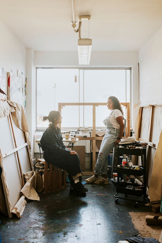 Woman artists sitting and relaxing inside of their art studio 