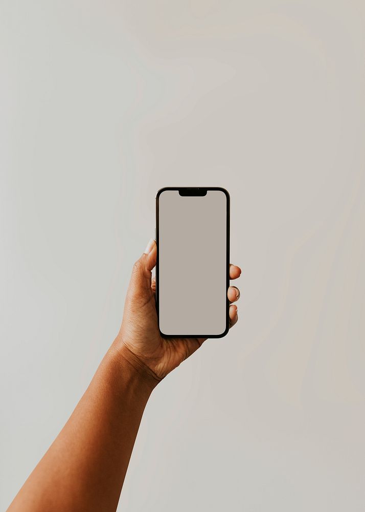 Person taking a photo with phone camera with blank photo screen and blank white wall 