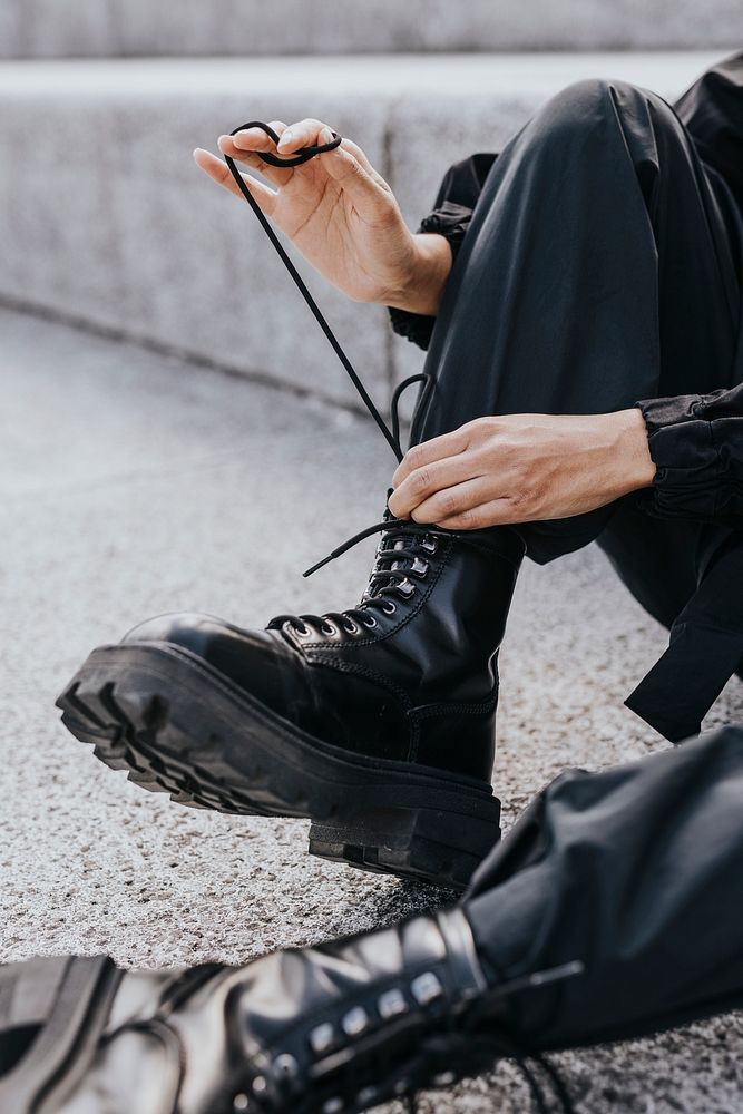 Person tying boots shoelaces