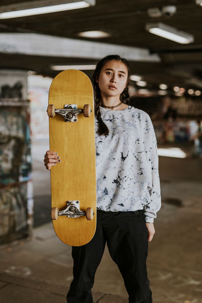 Cool Asian woman in skate park