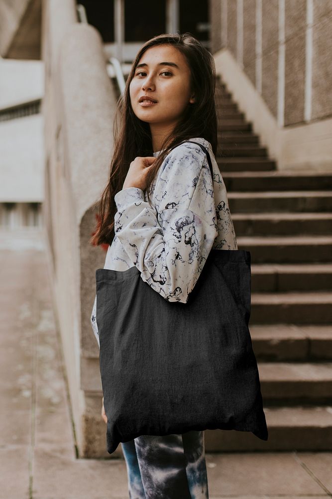 Woman using black tote bag, minimal design