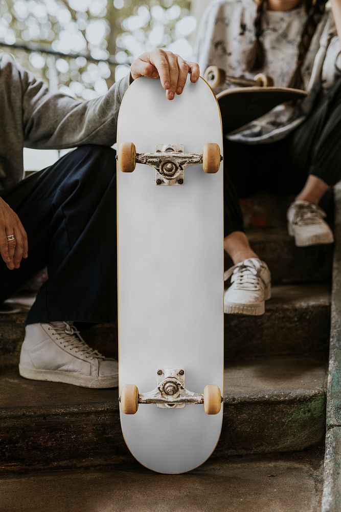 White skateboard, held by man