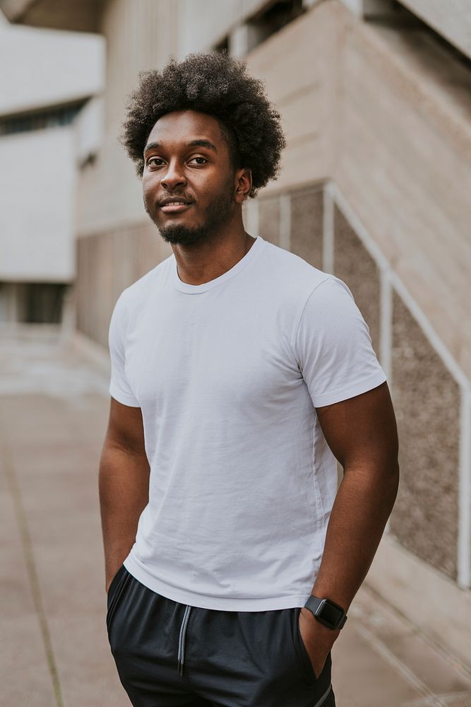 Cool man in plain whit tee, standing by stairs