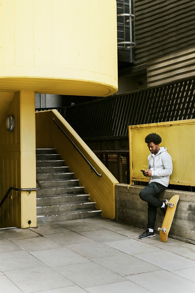 Skater waiting at yellow stairs