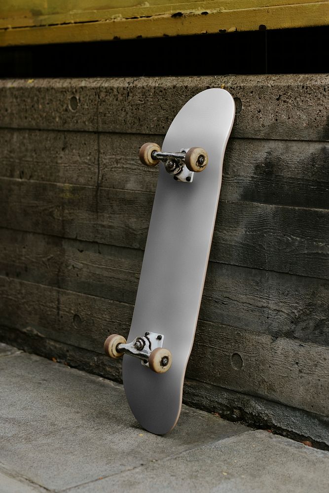 Gray skate leaning on concrete wall