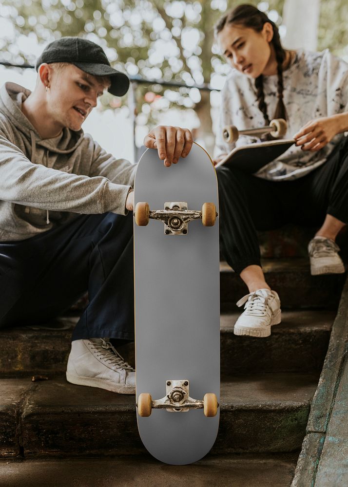 Friends sitting at skate park's steps