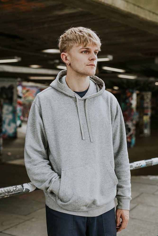 Cool blond man in gray hoodie at skate park