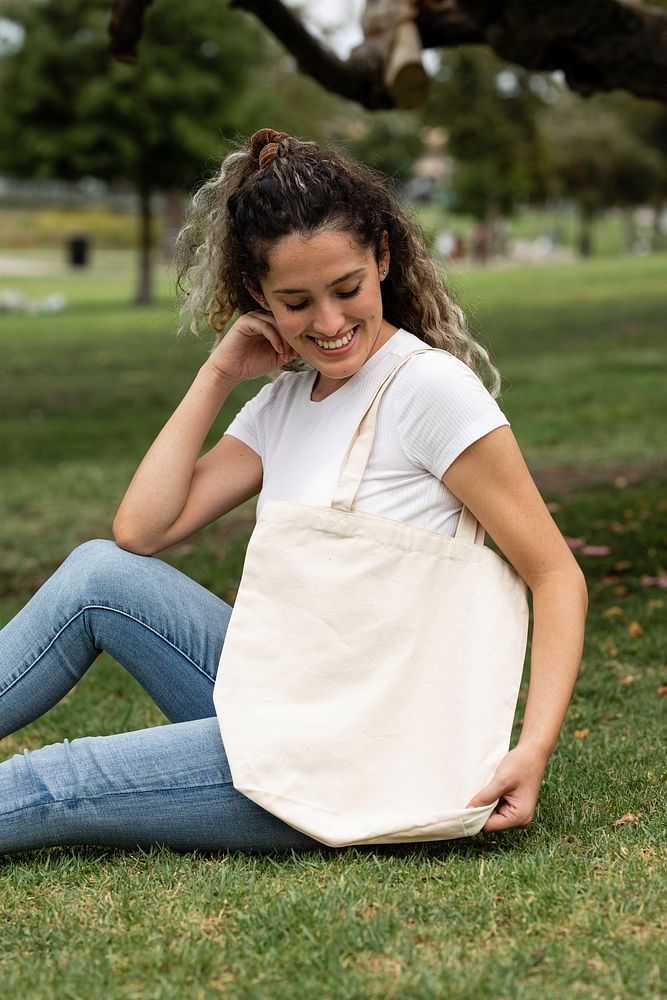 Woman with tote bag in a park, summer holiday