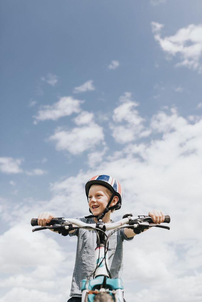 Kid&rsquo;s hobby background, boy riding a bike, summer hobby